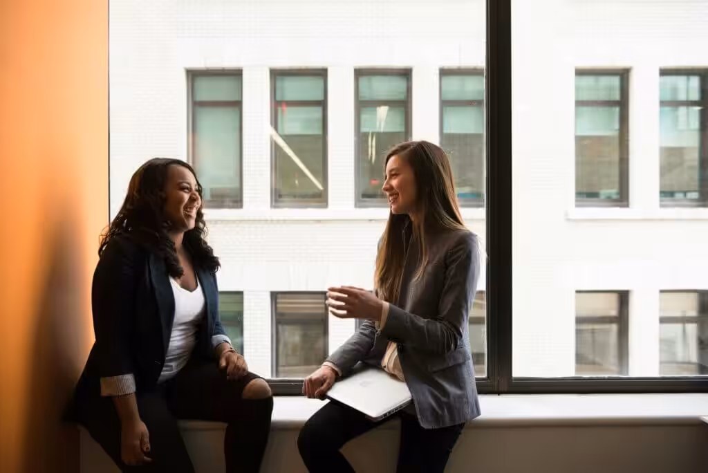 Business women sitting on windowsill
